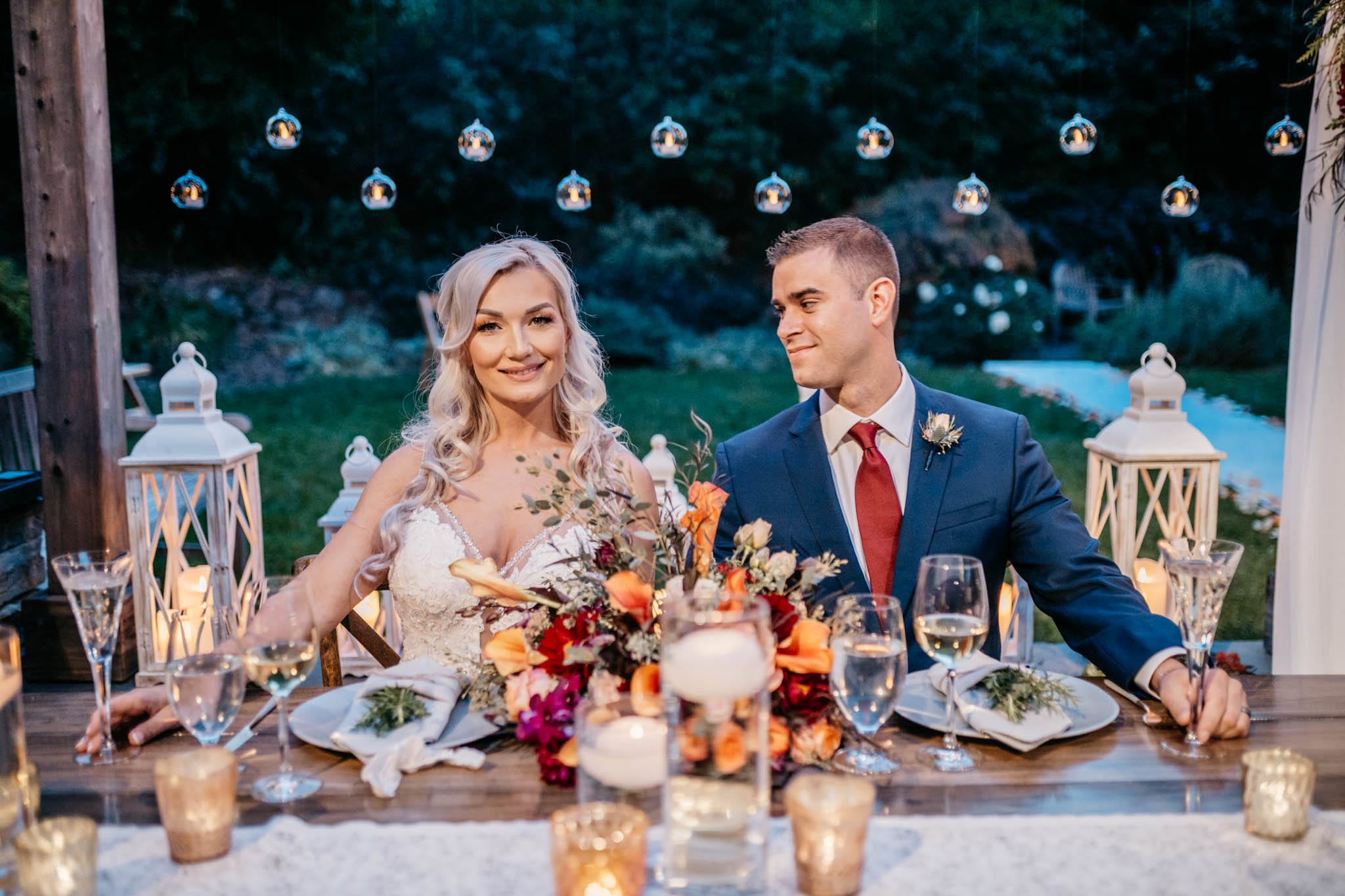A couple at their candlelit Wine Country wedding reception
