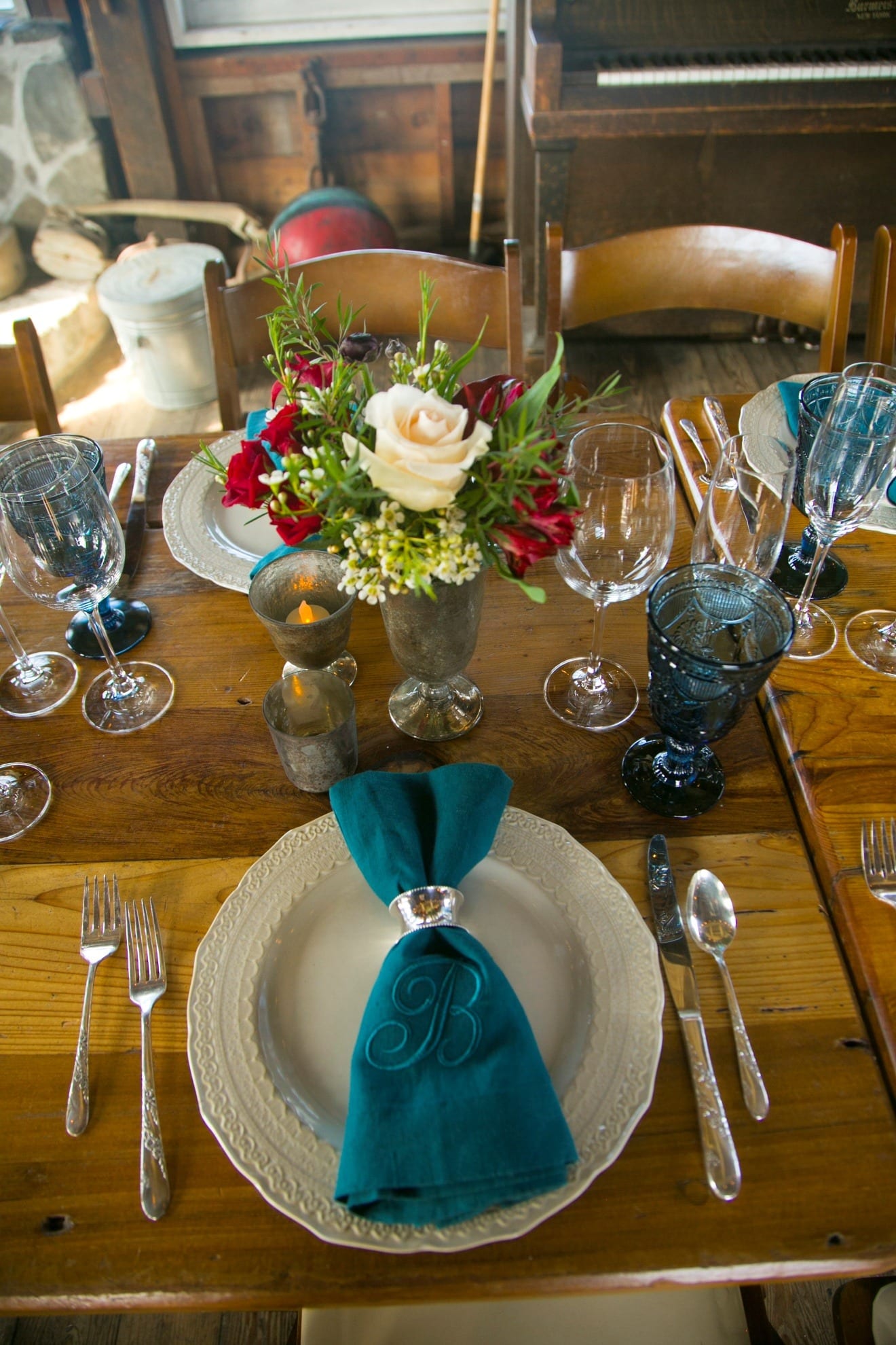 A rustic wedding place setting with a monogrammed napkin